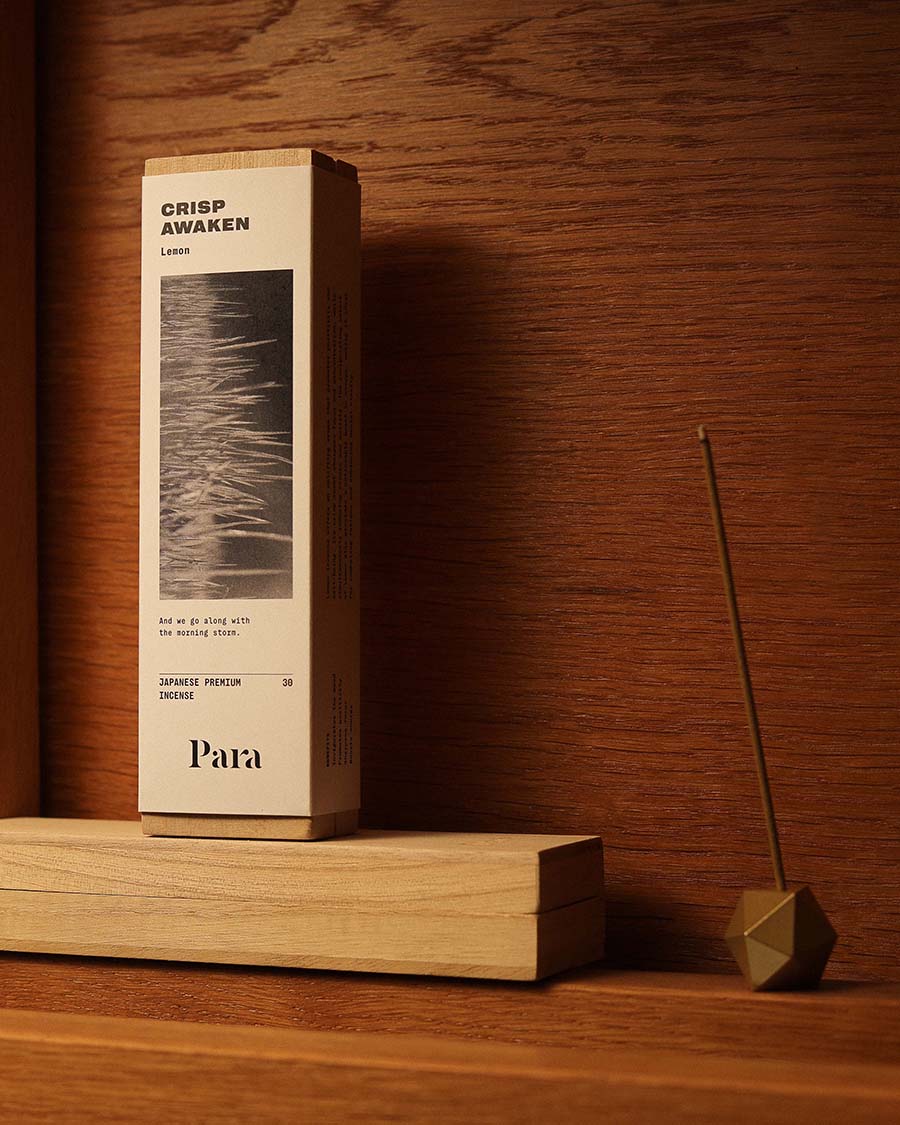 Para Crisp Awaken incense box on a wooden surface with a incense and incense holder.