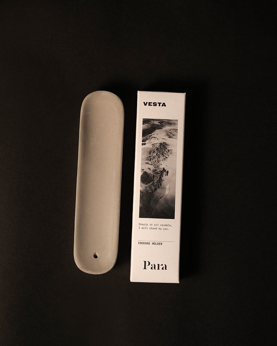 Natural concrete incense ash tray holding a traditional Japanese incense stick
