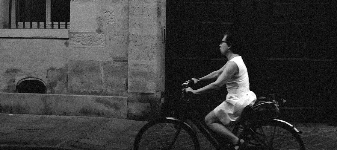 Woman riding a bicycle in an urban setting