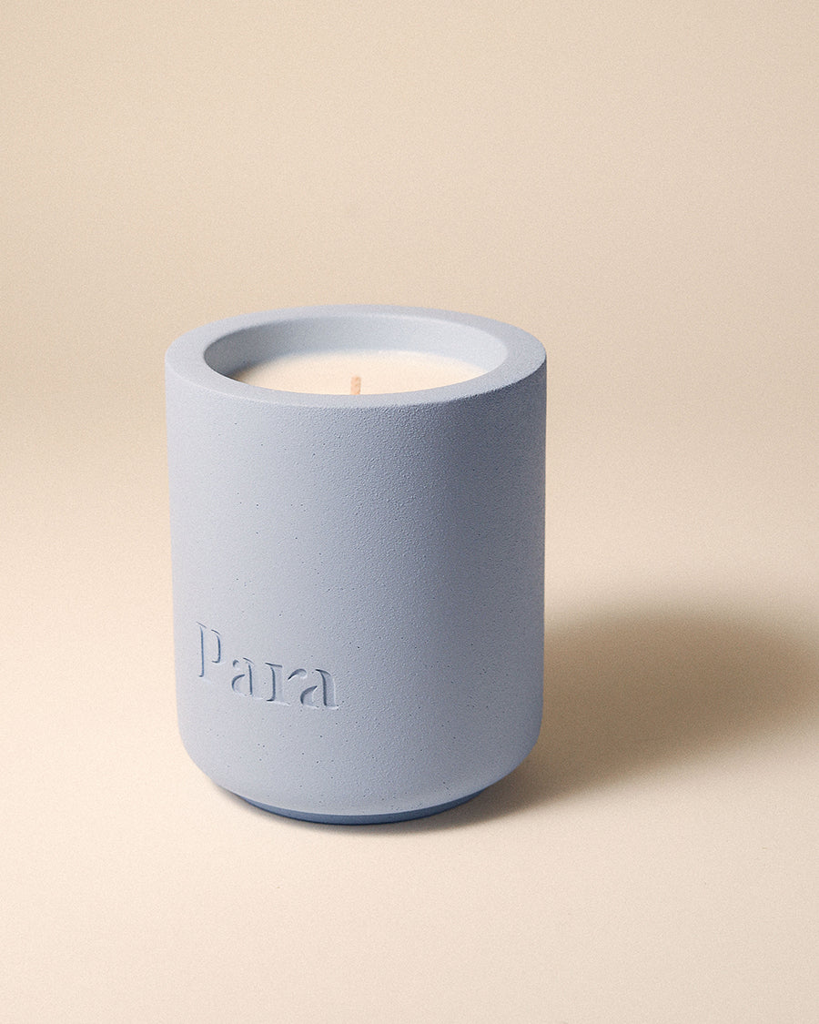 Blue concrete candle resting in a modern home setting, scent notes of cedarwood and amber