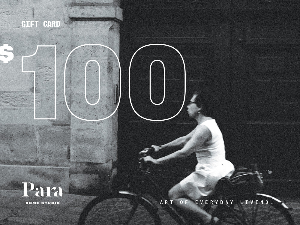 Gift card with a person riding a bike against a dark background, featuring the brand 'Para Home Studio' 100 dollars
