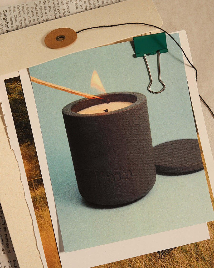 Minimalist black cement candle jar with lid featuring luxury palo santo and incense fragrance