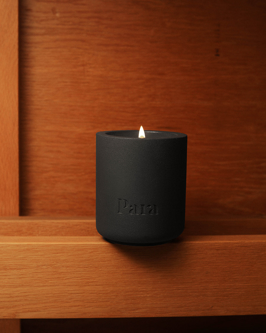 Minimalist black cement candle jar with lid featuring luxury palo santo and incense fragrance